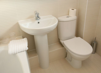 Interior of modern bathroom with white suite