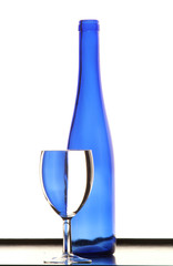 Blue bottle with blue wineglass on the table