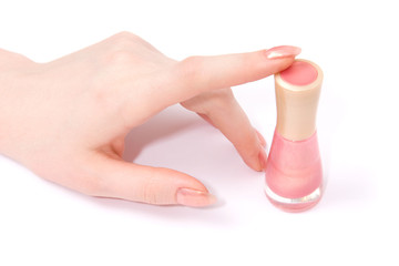 Woman hand with nail varnish. Bright soft pink colors.