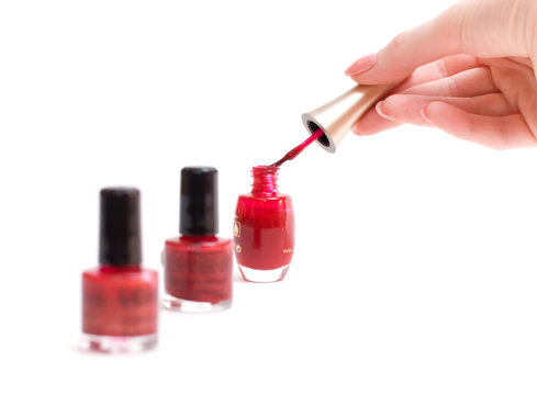 Woman hands with red paint and brush. Isolated on white.