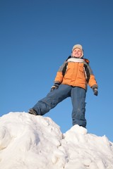 boy stands on snow hill