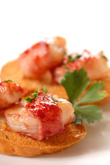 Bacon wrapped shrimp crostini with a cranberry apple glaze