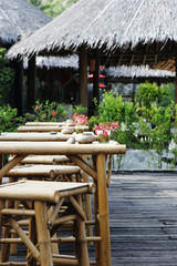 Table and chairs at an outdoor bar in the tropics.