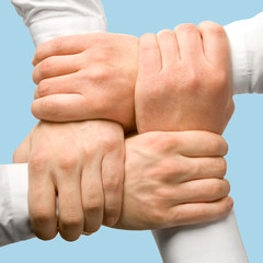 Photo of business people’s hands touching each other