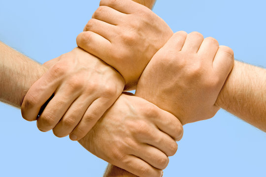 Image of crossed hands isolated over blue background