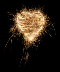 SParkling heart made of fireworks on black background