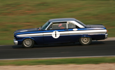 Obraz na płótnie Canvas vintage racing car in action on the racetrack.