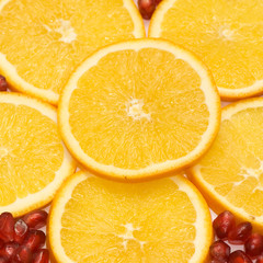 Fruit background from a orange and seeds of a pomegranate.