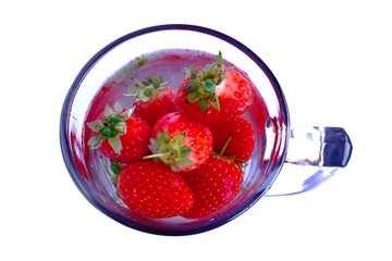 strawberries floating in a mug of water