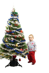 Baby girl and christmas tree isolated on white background