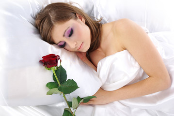 WOman in bed with red rose