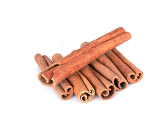 Cinnamon sticks tower on a white background