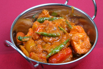 Hot Indian chicken curry in serving dish