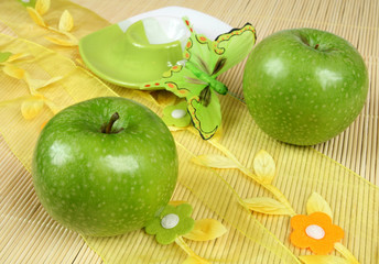 Beautiful natural green apples and decorated bamboo mat