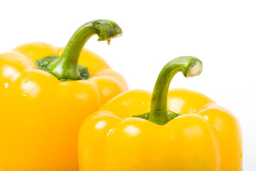 two yellow closeup peppers