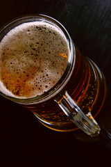 Beer mug close up over black background