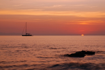 Sailing boat silhouette and sunrise 