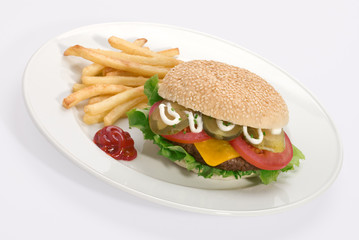 A loaded cheeseburger with french fries and tomato sauce