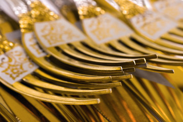 Macro of golden forks, food background