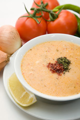cream soup with vegetables on white background