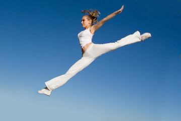 woman jumping, doing split leap