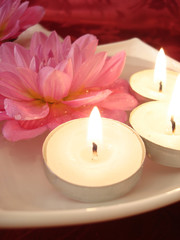 Spa essentials (candles and pink flowers on water)