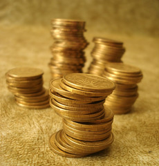 Stack of golden coins on yellow background