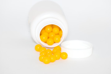 Yellow round vitamins were scattered from vial .