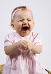 Little girl crying or laughing with closed eyes