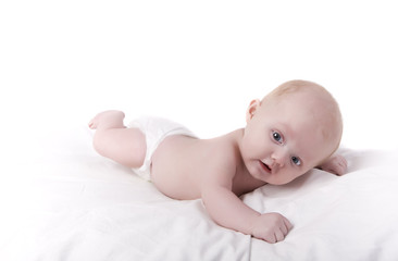 A newborn baby on a white sheet