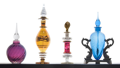 Exotic perfume bottles on white background