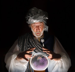 Swami gazing into a crystal ball