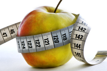 apple with meter wrapped around it. healthy lifestyle.