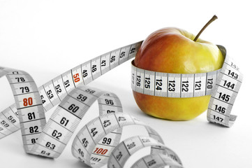Meter and apple with focus on apple.