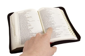 opened bible with indicating finger
