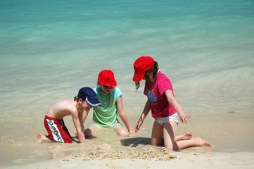 Fototapeta na wymiar three children playing on tropical beach