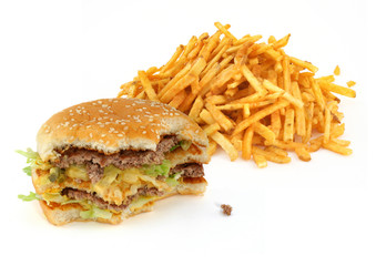 half-eaten hamburger and french fries against white background