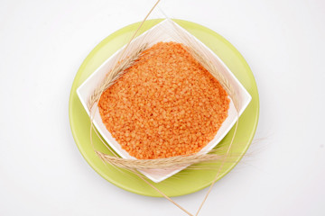 white background with dried orange lentil 