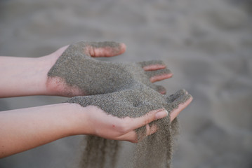 fine sand leaking through hands