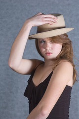 The young beautiful girl in a  beige hat