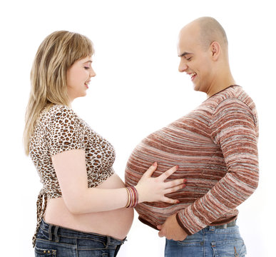 humorous picture of pregnant couple over white