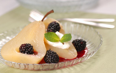 Fresh bartlett pear poached in wine with a blackberry sauce