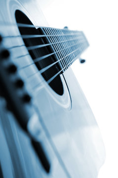 Acoustic guitar close up on white background