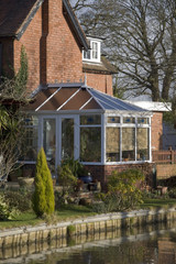 A conservatory  room in house next to garden
