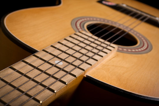 Close-up of classic acoustic guitar. Shallow DOF..