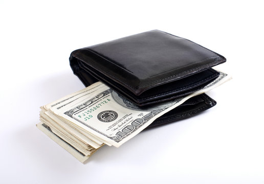 Money sticking out from wallet. White background. Shallow DOF..