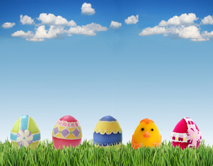 Easter eggs in grass on sky background