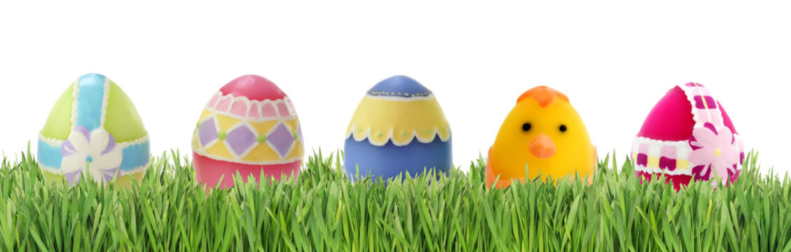 Easter eggs in grass isolated on white background