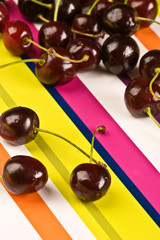 some ripe cherries on the colored background