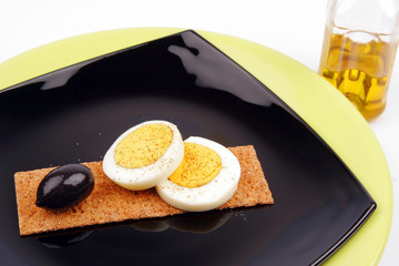 fiber egg black olive and olive oil on a black and green plate